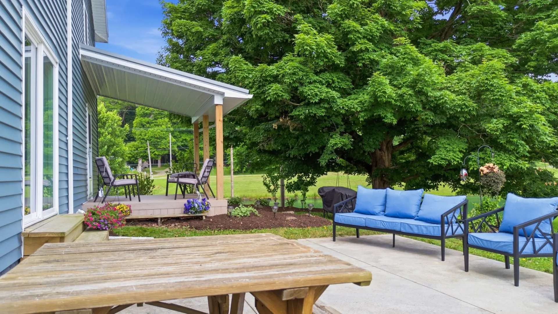 Covered back porch and patio of an Erie County farmhouse listing