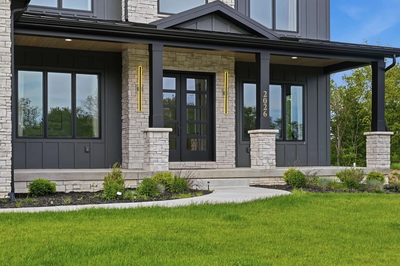 Covered stone front porch of a modern farmhouse near Pittsburgh